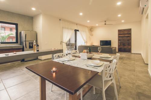 a dining room and kitchen with a table and chairs at Panacea Condo Tulum in Tulum