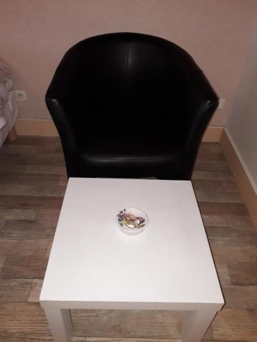 a black chair and a white table with a black chair at Hotel Le Beauregard in Divonne-les-Bains