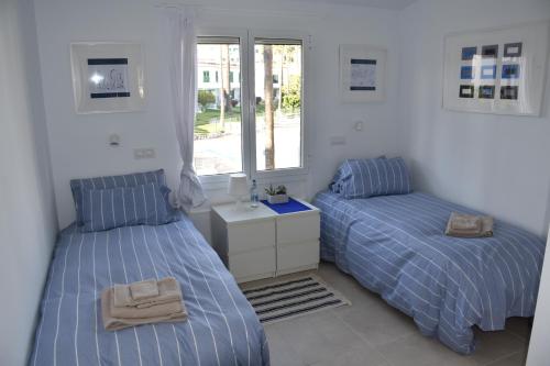 a bedroom with two beds and a window at MASPALOMAS - Area Ciudad in Playa del Ingles