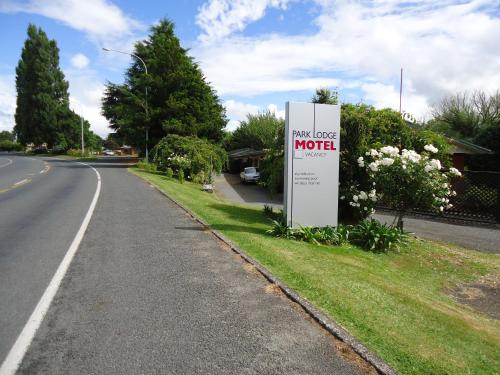 a sign for a motel on the side of a road at Park Lodge Motel in Te Awamutu
