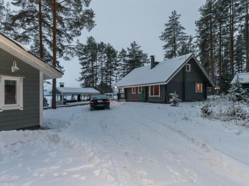 un coche aparcado frente a una casa en la nieve en Holiday Home Villa helge by Interhome en Savitaipale