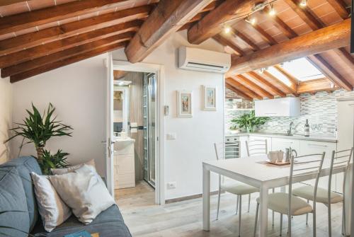 a kitchen and dining room with a table and chairs at Cascine Home Holidays in Florence