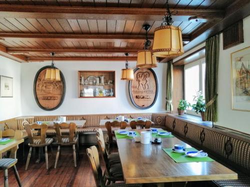 a dining room with a large wooden table and chairs at Grüner Baum in Langenau
