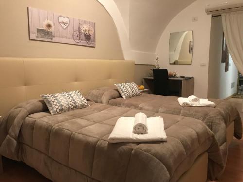 A bed or beds in a room at AFFITTACAMERE Il Cortile