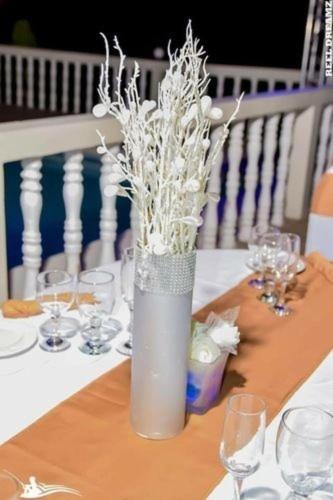 a vase filled with white flowers on a table at Retreat Guest House in Falmouth