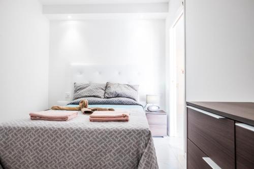 a bedroom with a bed with towels on it at Guayero in Los Cristianos