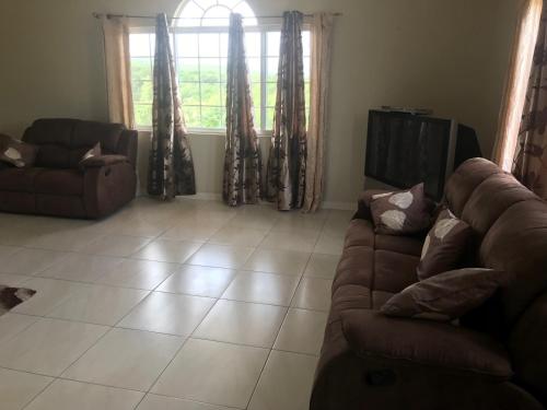 a living room with a couch and a window at Retreat Guest House in Falmouth