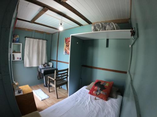 a small bedroom with a bunk bed and a desk at Leo's Den in Fish hoek