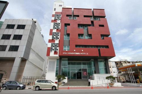 a building with cars parked in front of it at Ipoh Downtown Hotel in Ipoh