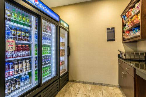 a refrigerator filled with lots of drinks in a store at Cobblestone Hotel & Suites - Torrington in Torrington
