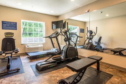 a gym with several exercise bikes and a mirror at Cobblestone Hotel & Suites - Torrington in Torrington