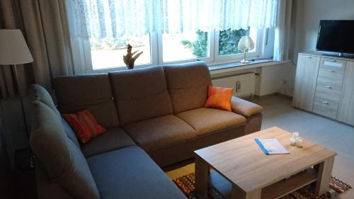 a living room with a couch and a table at Ferienwohnung Berger in Greven