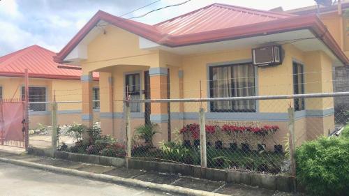 a house with a fence in front of it at Jireh’s Guests Home in Butuan