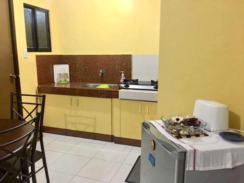 a kitchen with a counter and a sink and a stove at Jireh’s Guests Home in Butuan