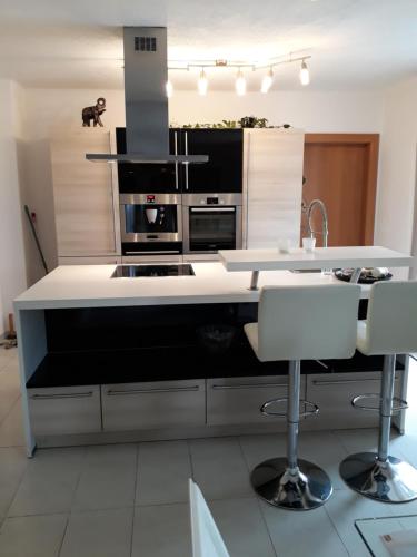 a kitchen with a white counter and a stove top oven at Appartement Fortuna in Saalfelden am Steinernen Meer