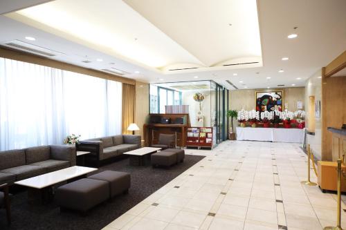 a lobby of a hotel with couches and tables at Hotel Sunroute Asakusa in Tokyo