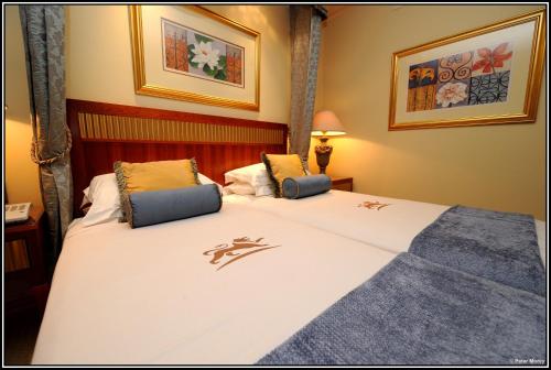 a hotel room with two beds in a room at Peermont D'oreale Grande at Emperors Palace in Kempton Park
