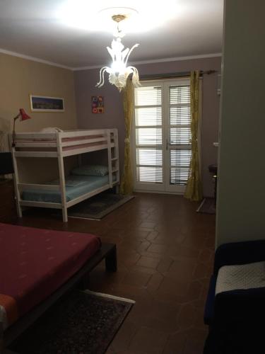a living room with bunk beds and a chandelier at B&B Filomena in Santa Giusta