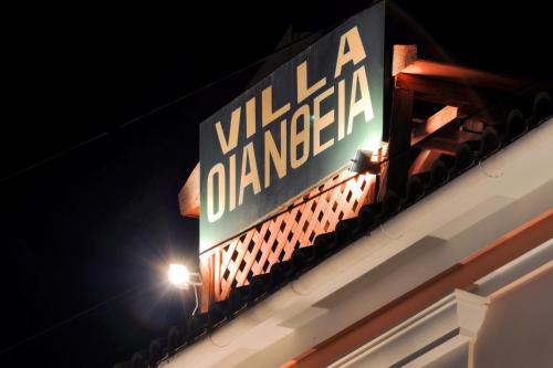 a sign on the side of a building with a light at Villa Ianthia in Galaxidhion