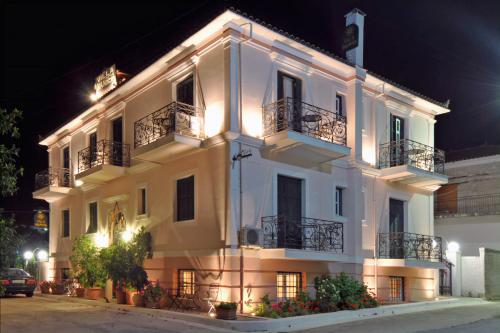 a large white building with balconies and lights at Villa Ianthia in Galaxidhion