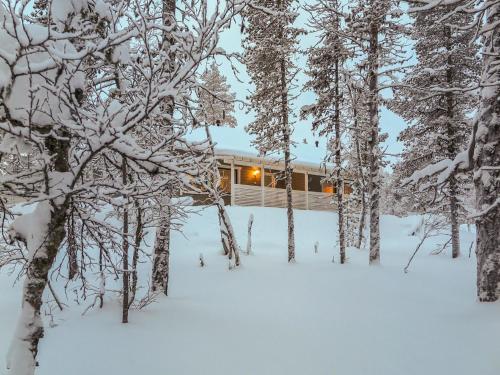 a cabin in the woods in the snow at Holiday Home Hilla b by Interhome in Saariselka