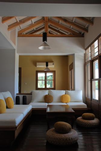 a living room with two white couches and two windows at VILLA ISMINI, Skiathos in Skiathos
