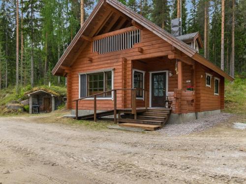 a cabin in the woods with a dirt road at Holiday Home Vuorilahti by Interhome in Savonranta