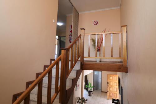 a staircase in a home with wooden railings at Sentosa Guest House in Francistown