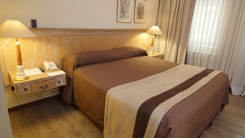 Ένα ή περισσότερα κρεβάτια σε δωμάτιο στο Hotel Diego de Almagro Santiago Centro