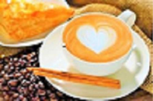 a cup of coffee with a heart on a plate at Martin House & Granada in Granada