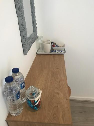 a table with two bottles of water and a mirror at The Bungalow in Leeds