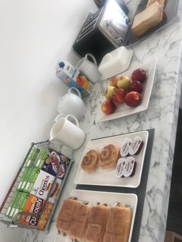 a counter top with plates of food and fruits on it at The Bungalow in Leeds