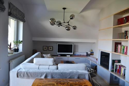 ein Wohnzimmer mit einem Sofa und einem TV in der Unterkunft Tarnów Dom / Apartament w Centrum in Tarnów