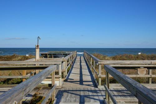 a wooden boardwalk leading to the beach at Outer Banks Beach Club in Kill Devil Hills
