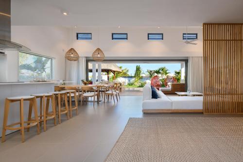 a living room with a white couch and a table at Luxurious Villa - Beach 1039m, Golf & Malls 4mn in Grand Baie
