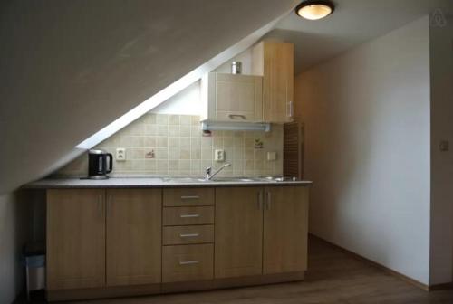 Kuchnia na poddaszu ze zlewem i schodami w obiekcie Apartman U Hřiště Krkonoše w mieście Prostřední Lánov