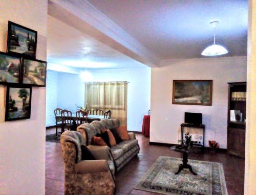 a living room with a couch and a dining room at Casa Vale do Rio Ovil in Baião