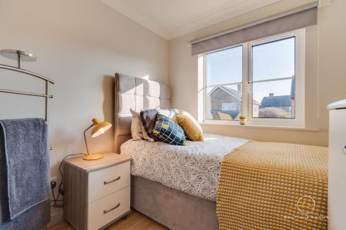a bedroom with a bed and a window at The Buddha House Huntingdon Boutique Rooms in Godmanchester