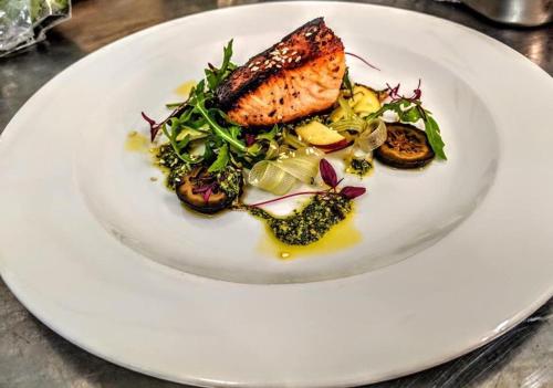 a white plate with a dish of food on a table at The Lion in Leintwardine