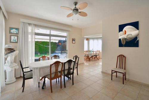 a dining room with a white table and chairs at Villa Daryah Sirina Bay in Protaras