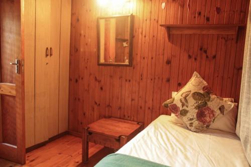 a bedroom with a bed and a wooden wall at Sodwana Bay Lodge House 34 in Sodwana Bay