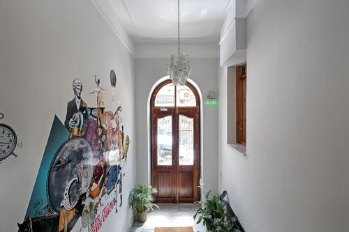 a hallway with a door and a painting on the wall at City Circus Athens in Athens