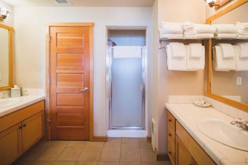 a bathroom with a shower and a sink and a mirror at Inn at Cape Kiwanda in Pacific City