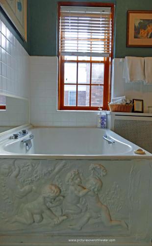 a bath tub with people on it in a bathroom at The Outing Lodge in Stillwater