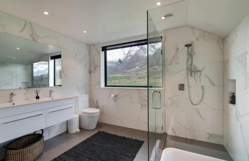 a bathroom with a shower and a sink at 4 Stockyard Lane by Sotheby's Luxury Rental Homes in Queenstown