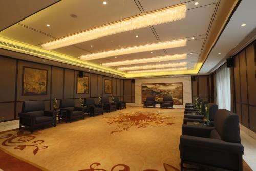 a large room with chairs and a waiting room at S&N Zhejiang LinHai International Hotel in Linhai