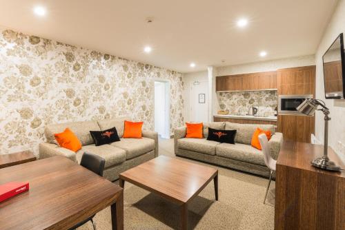 a living room with a couch and a table at Croydon Lodge in Gore