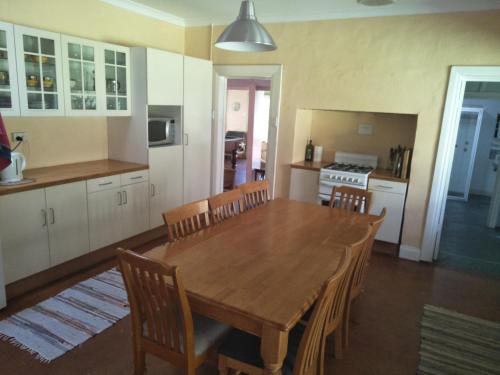 a kitchen with a large wooden table and chairs at Crystal Springs Holiday Accommodation in Walpole
