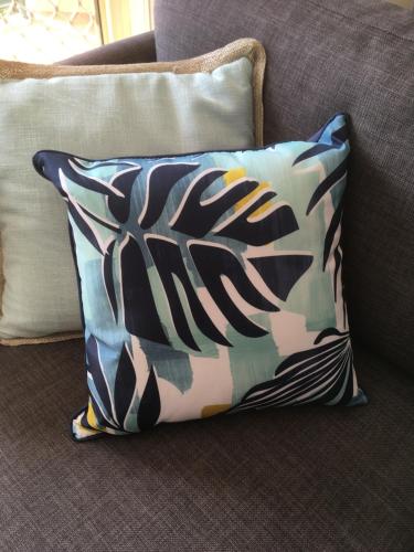 a pillow sitting on a couch with a camouflage at Town Beach Beachcomber Resort in Port Macquarie
