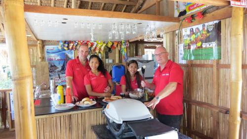 a group of people standing in a food cart at Binucot Beach Resort in Ferrol